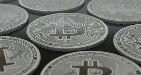 Stacked silver Bitcoin coins representing multi-stage swap routing
